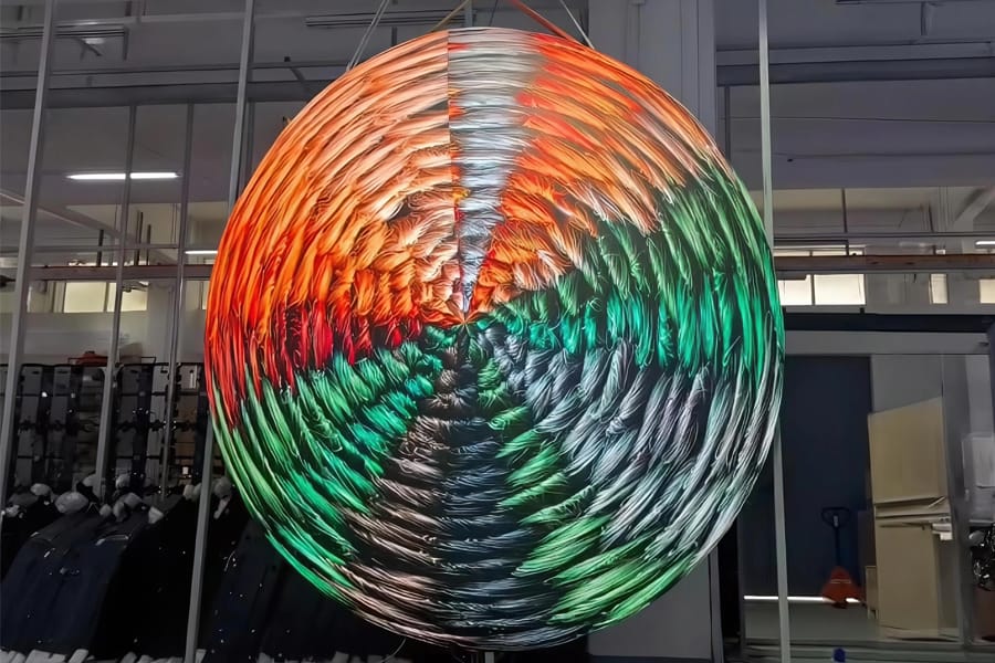 Custom flat circular LED display installed on retail column showing vibrant brand graphics