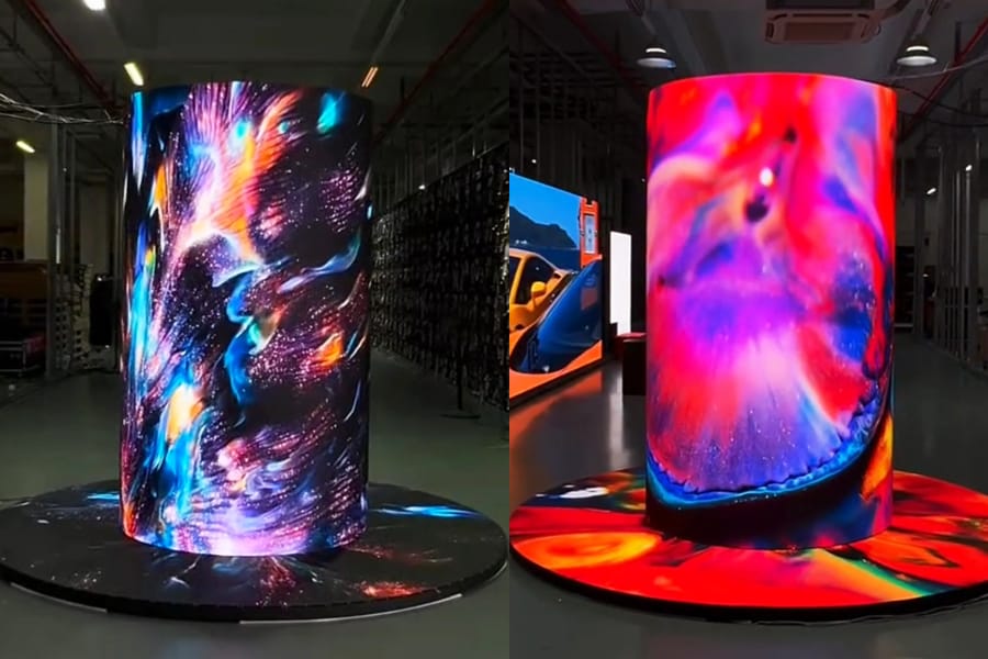 Custom cylindrical LED display wrapped around a building pillar showing dynamic blue video content in an airport lobby