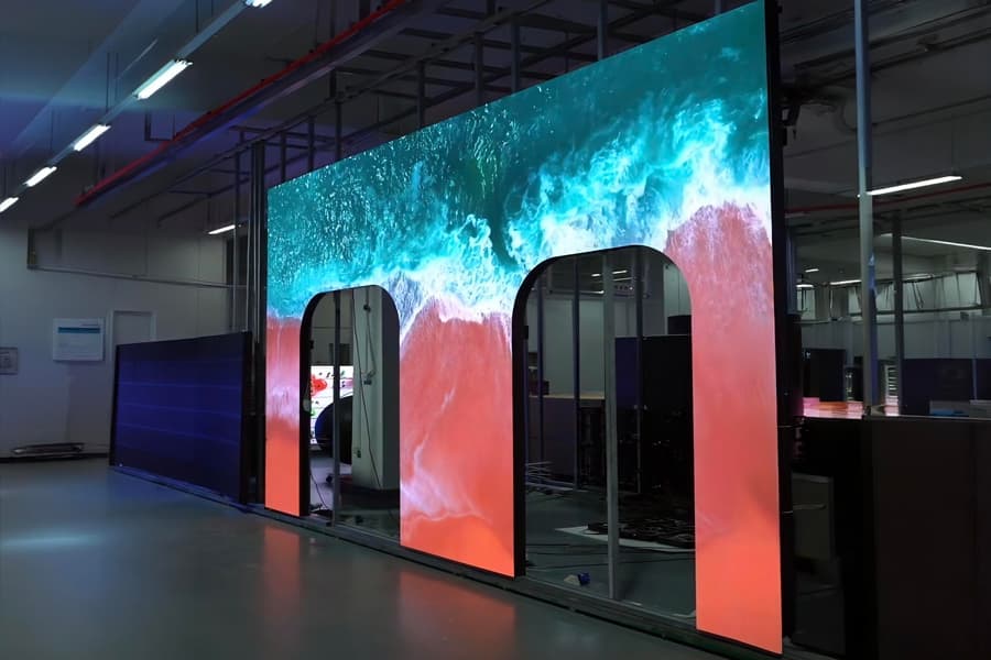 Close-up of dual-aperture LED screen showing seamless integration around door frames with vibrant digital content