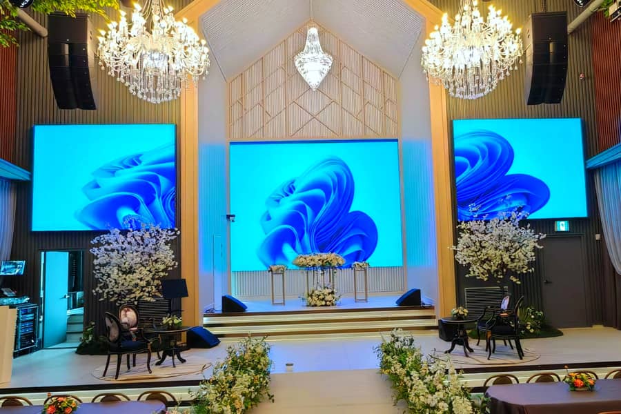 Large indoor LED display screen on stage at a modern worship center